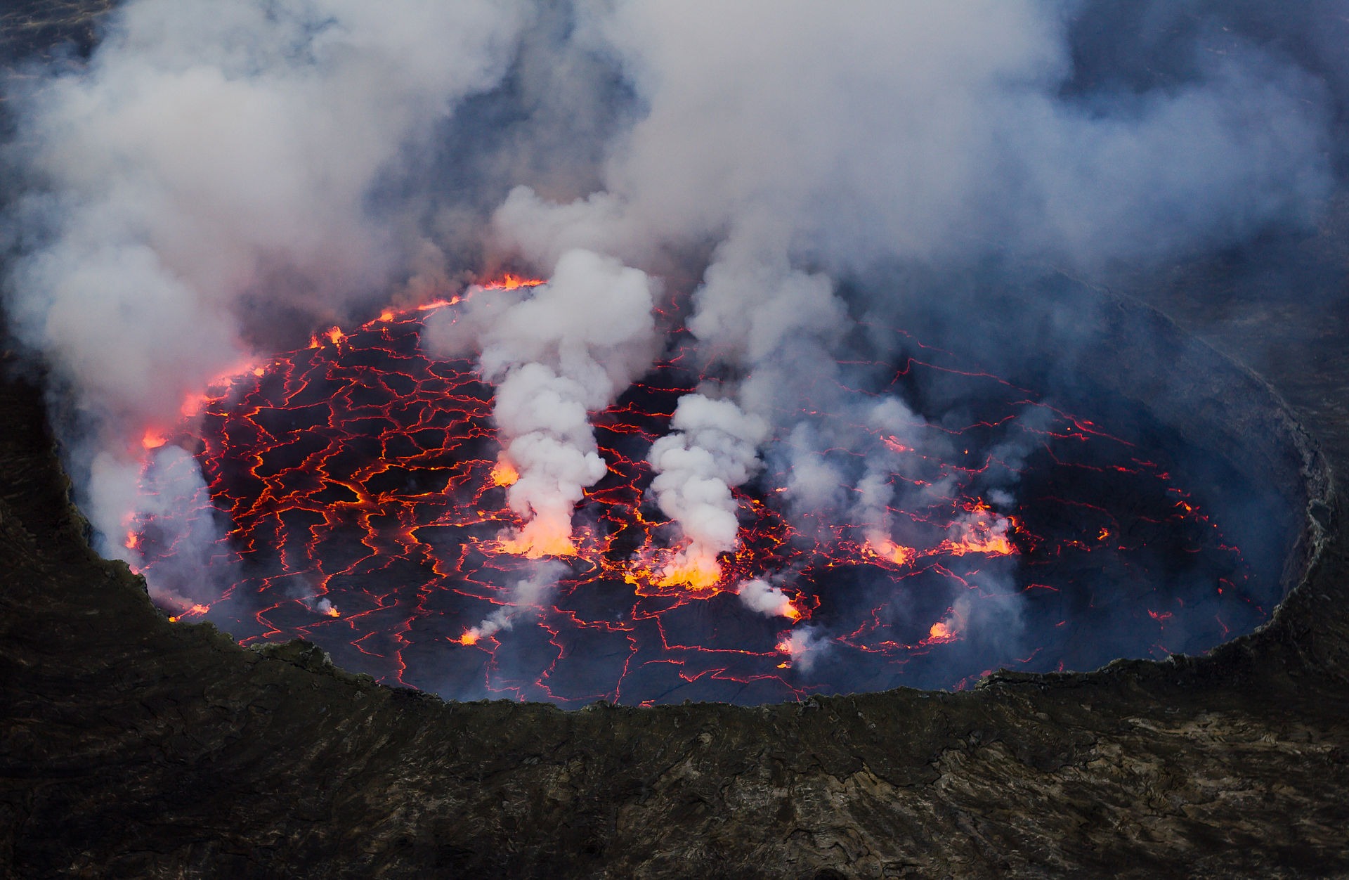 Photo of the Virunga National Park World Heritage site. Virunga national park in the Democratic Republic of the Congo has no less than seven volcanoes, two of which are the most active in Africa. The Nyiragongo volcano features a liquid, alkaline lava lake that fills its entire crater. The volcano’s periodic eruptions have catastrophic consequences for the surrounding areas. Photo: Cai Tjeenk Willink (CC BY-SA.3.0) via Wikimedia Commons